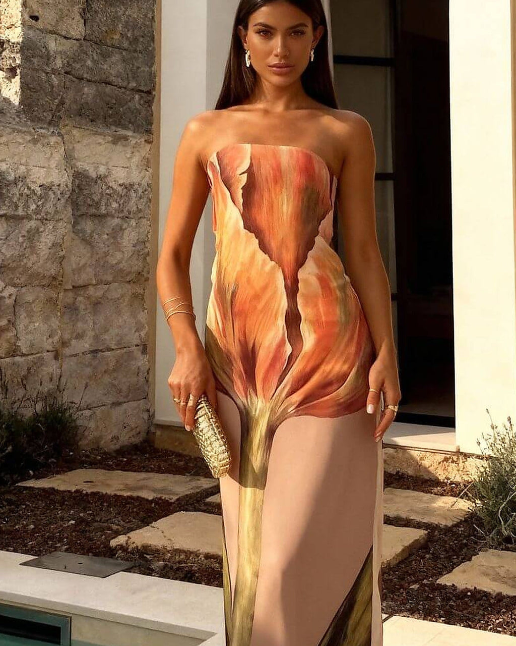 Brown and cream one-piece swimsuit with adjustable straps and elegant draping detail