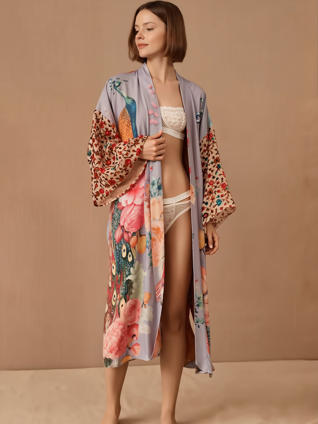 Woman wearing cream textured bikini with floral patterned kimono robe in shades of pink, red, and blue.