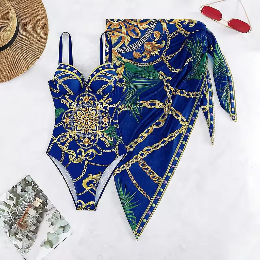 Sahara Silk bikini in royal blue with ornate gold chain and baroque print, paired with matching sarong wrap.