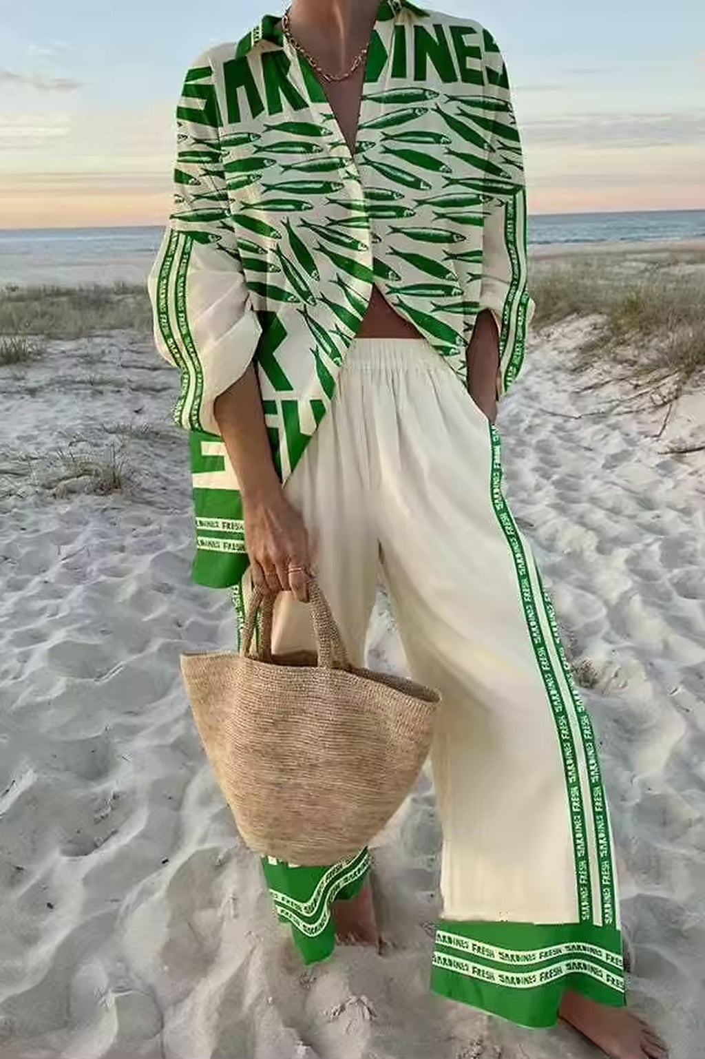 Woman wearing green and white striped Sahara Pop bikini with coordinating cover-up on beach at sunset