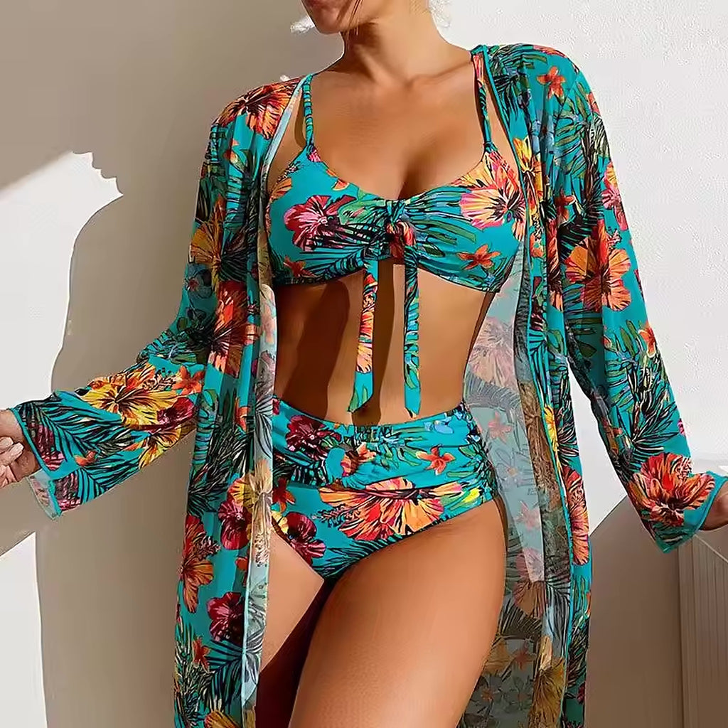 Turquoise floral bikini with matching sheer cover-up, featuring vibrant red and yellow tropical flowers and palm leaf print.