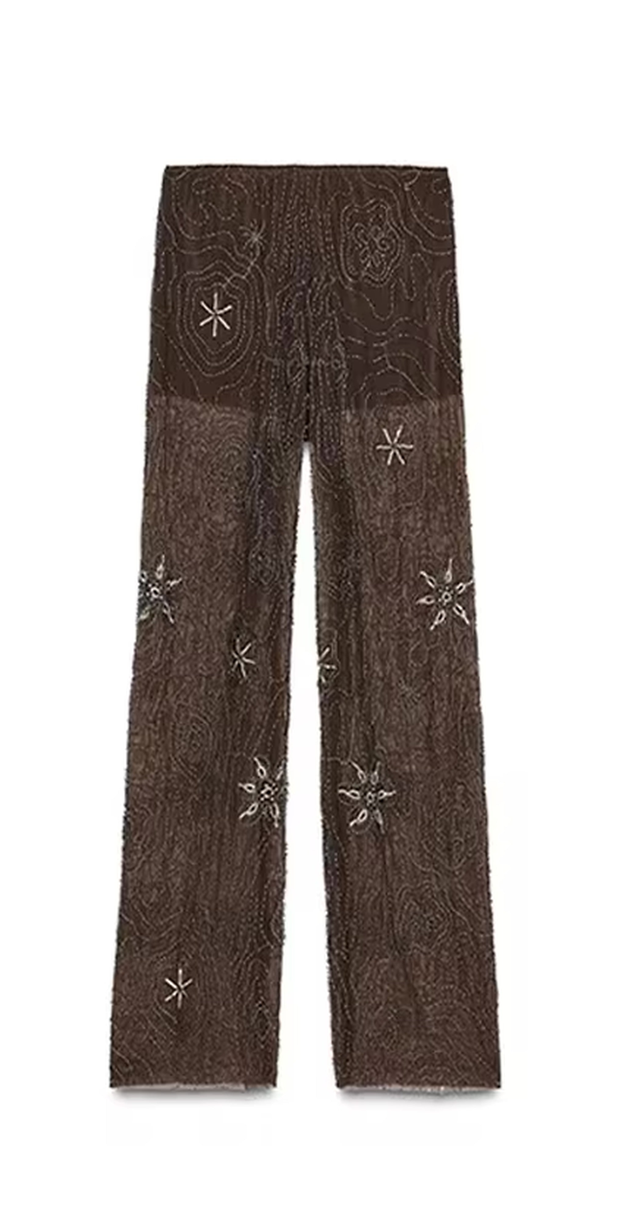 Brown wide-leg pants with celestial star and circular embroidery details throughout, featuring a textured woven fabric.
