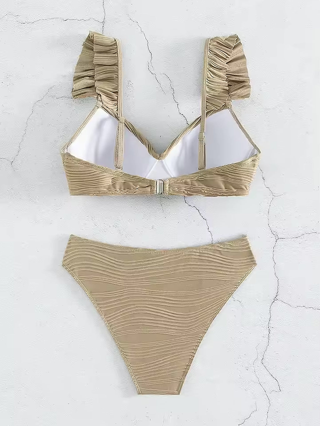 Beige ruched bikini with textured fabric, adjustable straps, and underwire top displayed on white background