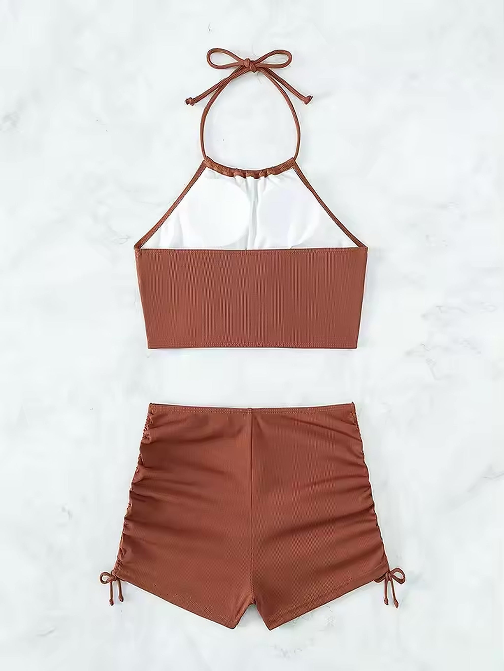 Terracotta ribbed bikini with halter neck top and high-waisted shorts featuring side tie details