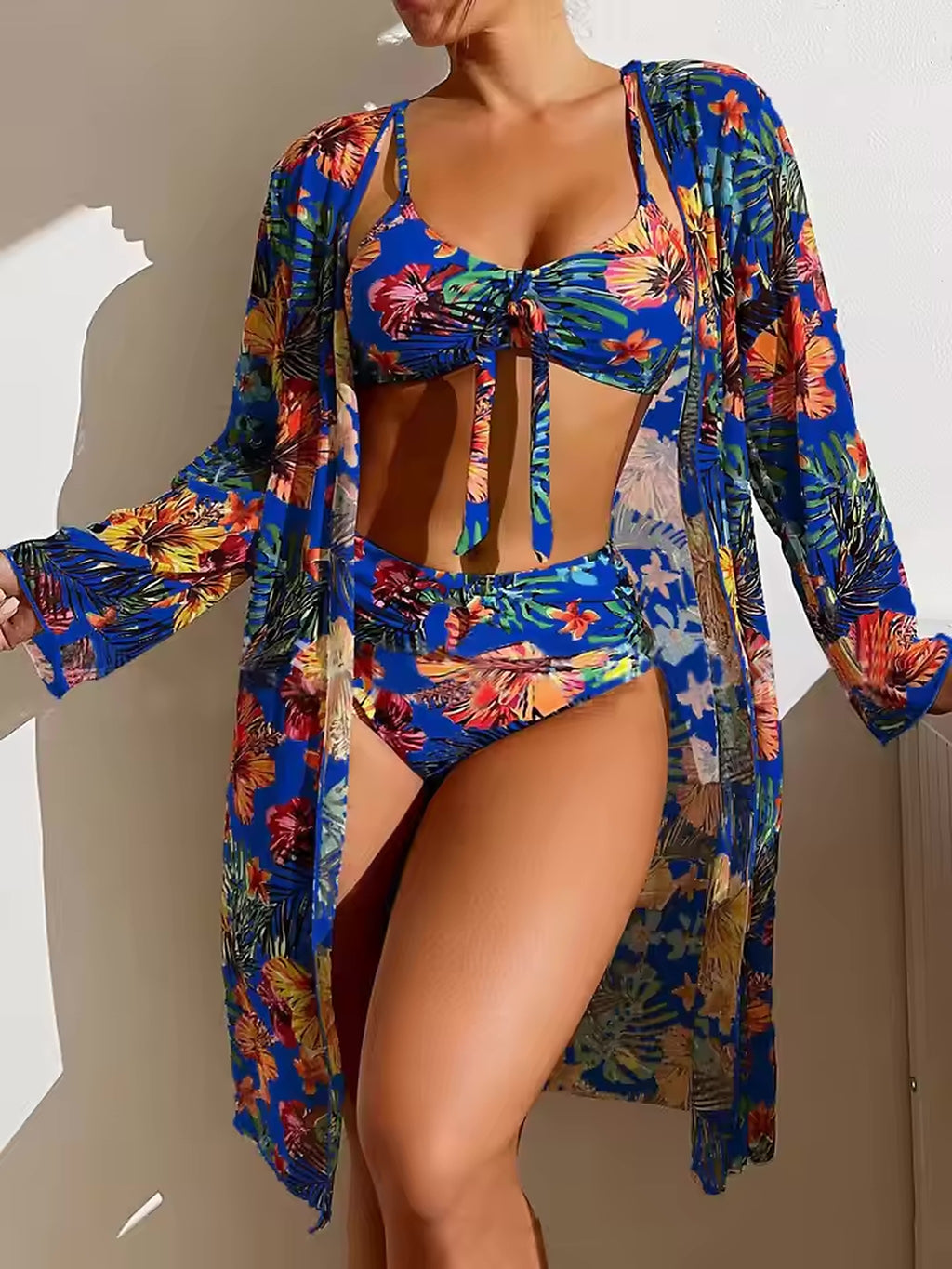 Vibrant floral bikini with matching cover-up in blue, orange, and yellow tropical print design.