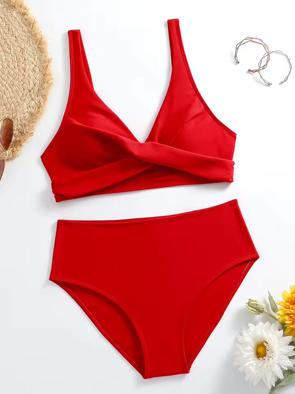 Red wrap bikini top with matching high-waisted bottoms, displayed with straw hat and beach accessories