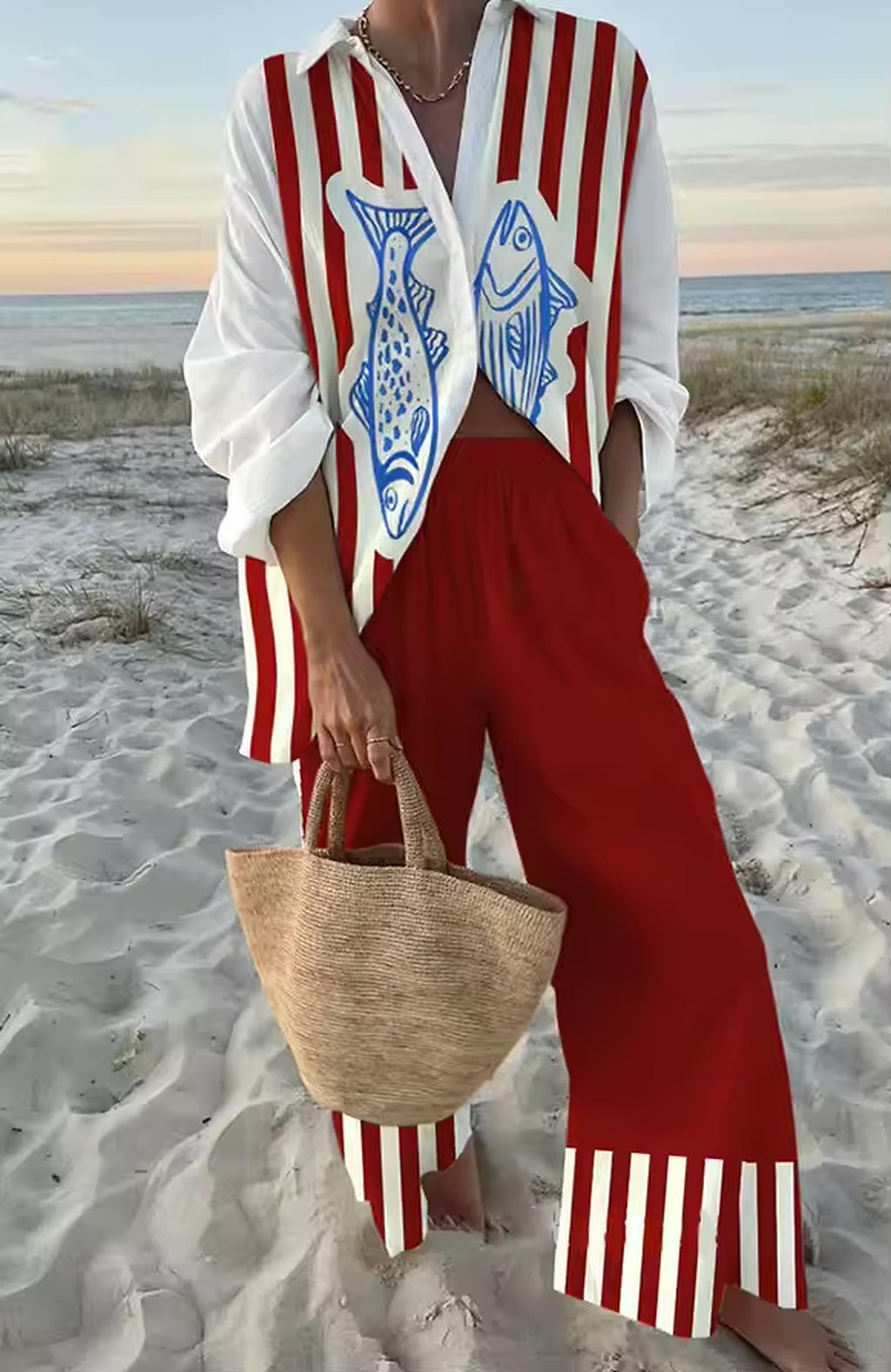 Red and white striped Savanna Siren bikini styled with beach cover-up on sandy shore